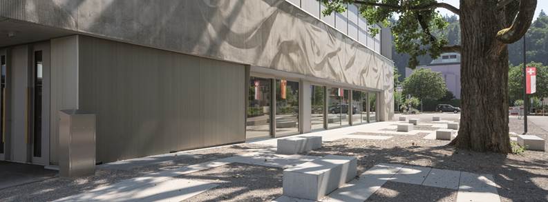 A building with windows and a sidewalk

Description automatically generated